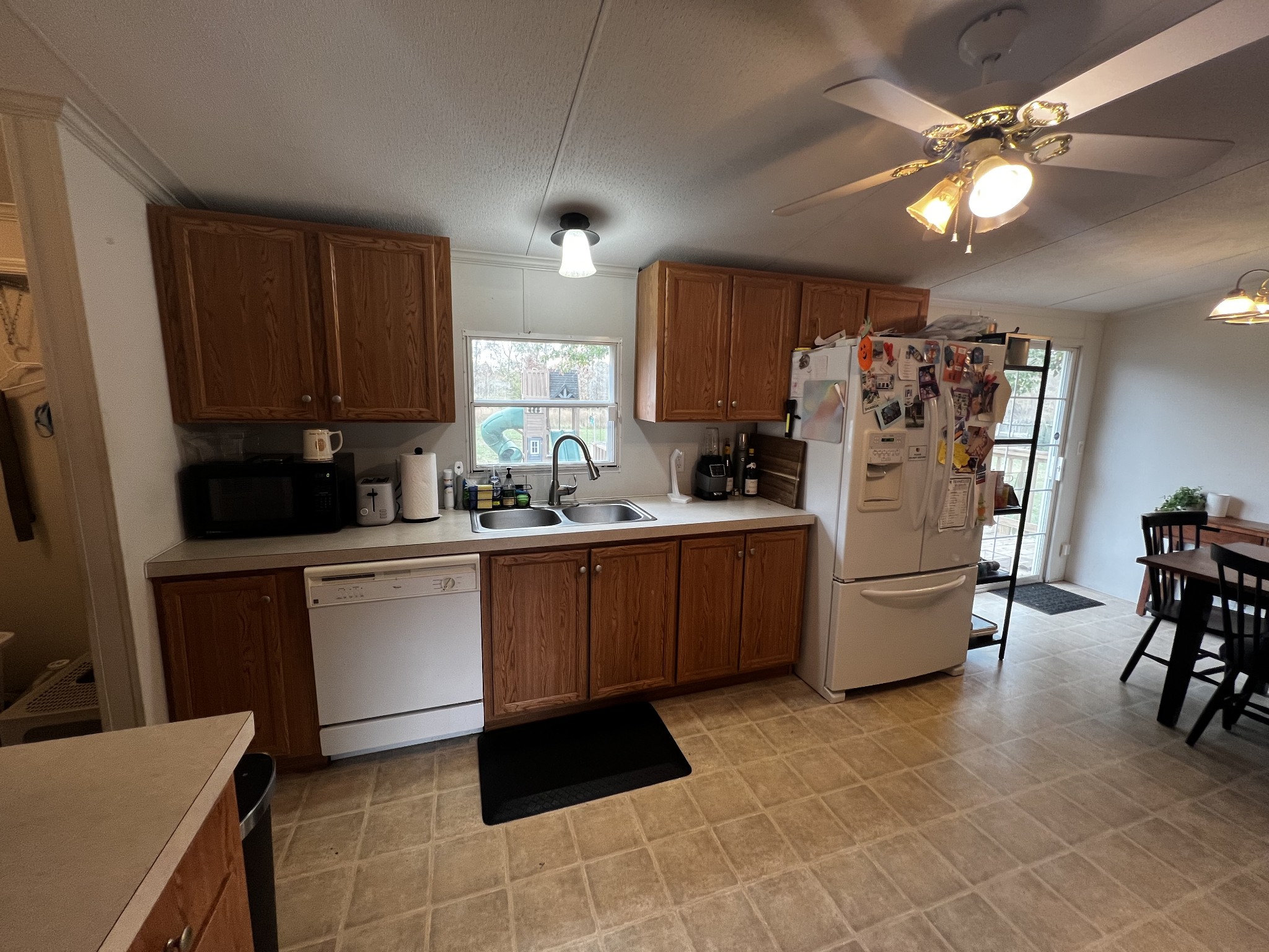 1870 Parker Road Manchester, TN 37355 - Photo 9 of 40 a kitchen with a refrigerator a microwave cabinets and a dining table