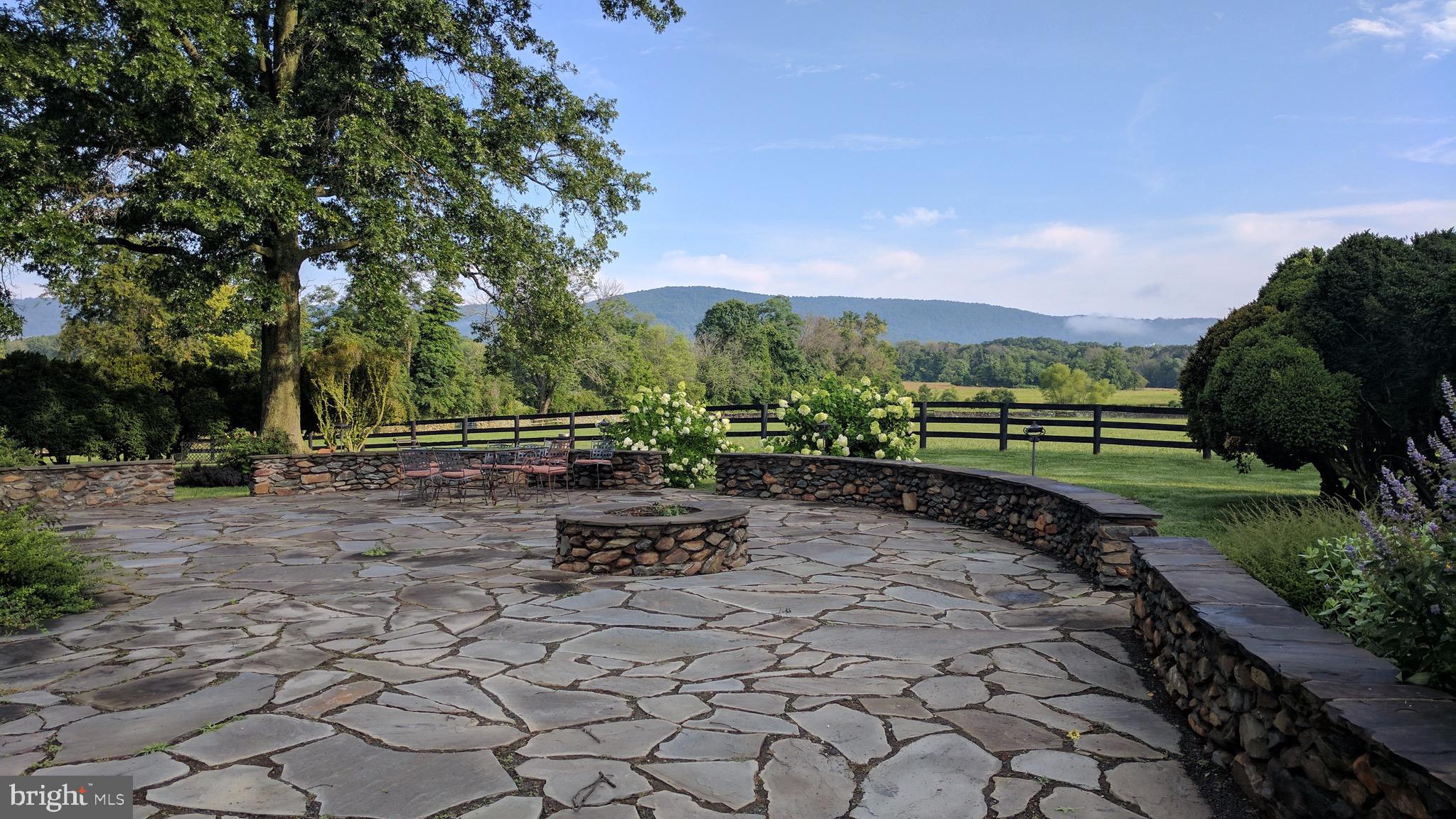 20775 Airmont Road Bluemont, VA 20135 - Photo 15 of 78 Stone patio with fire pit and wall off kitchen