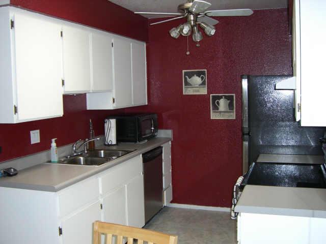 93 North Cooper Road, Unit 71 Chandler, AZ 85225 - Photo 4 of 6 a kitchen with a sink cabinets and chandelier