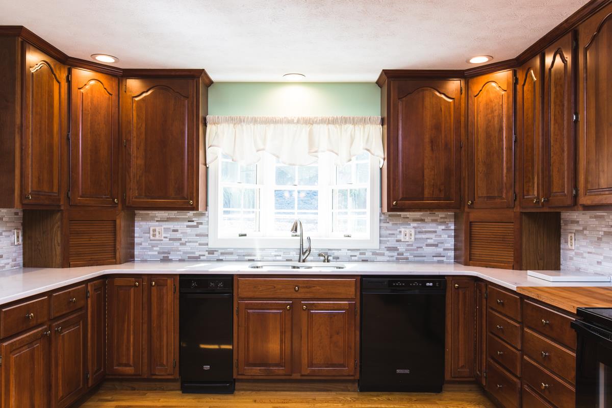 868 Todd Road Mount Sidney, VA 24467 - Photo 2 of 47 a kitchen with granite countertop wooden cabinets a sink and a window