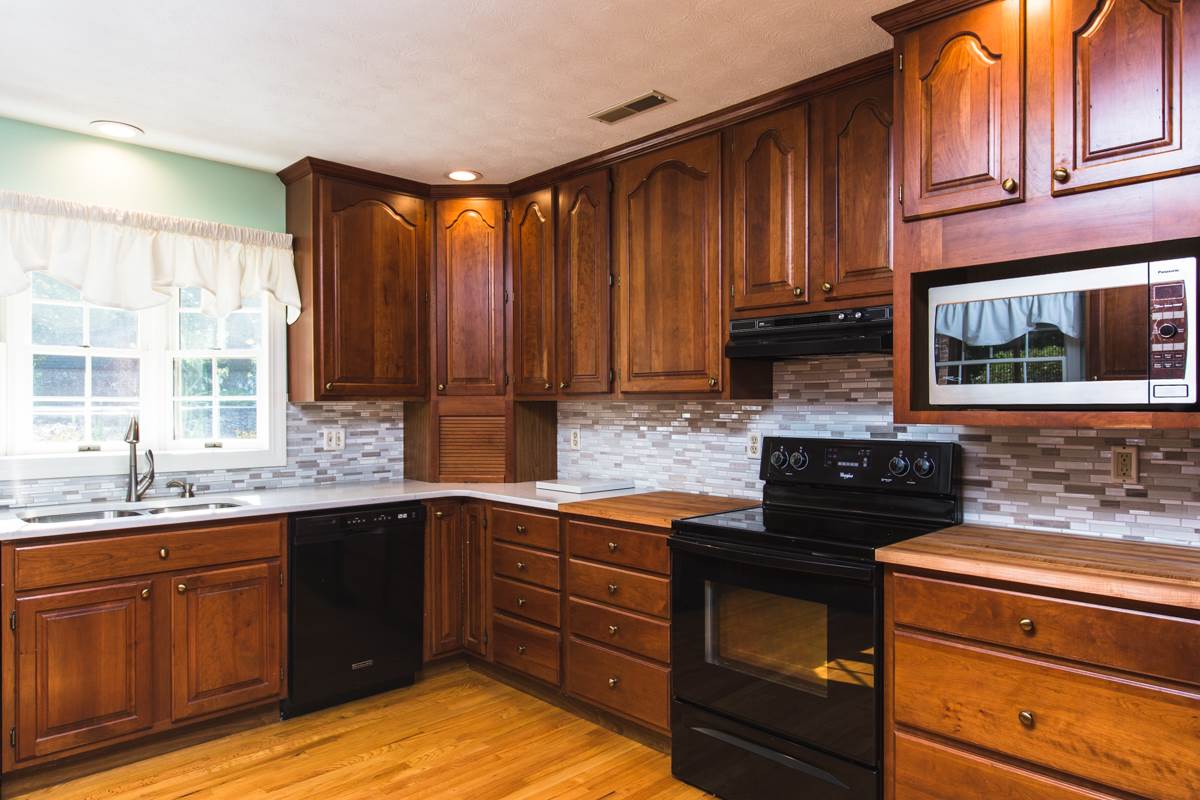 868 Todd Road Mount Sidney, VA 24467 - Photo 3 of 47 a kitchen with stainless steel appliances granite countertop wooden cabinets and a stove top oven