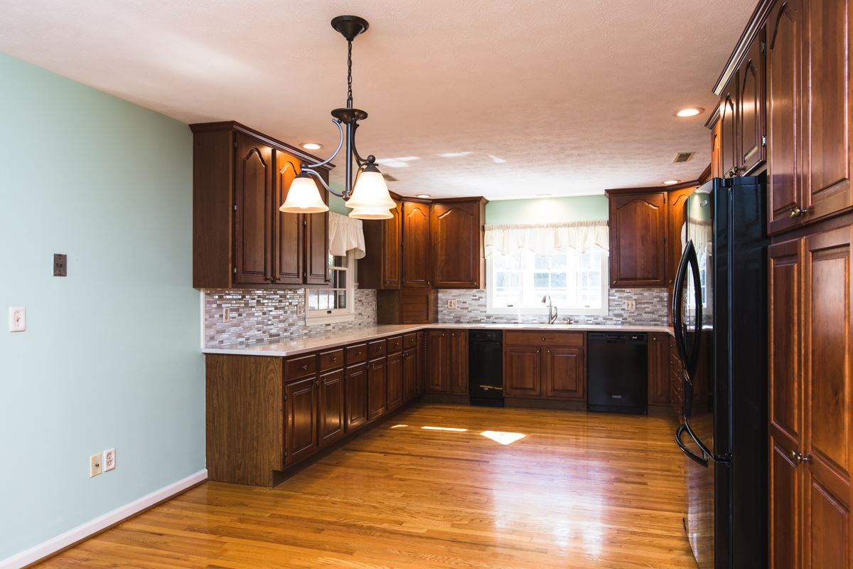 868 Todd Road Mount Sidney, VA 24467 - Photo 6 of 47 a kitchen with stainless steel appliances granite countertop a refrigerator a sink dishwasher a stove and white countertops with wooden floor