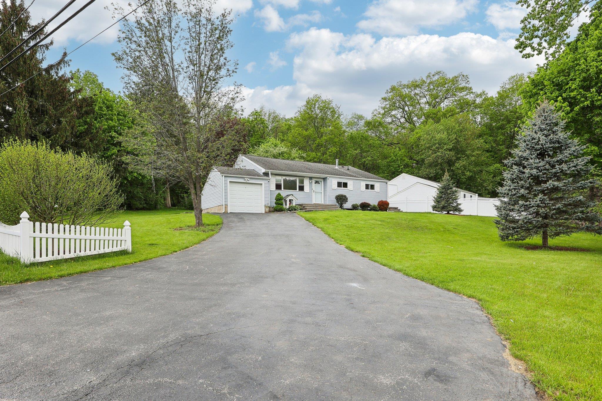 View of front of home with an attached garage and driveway