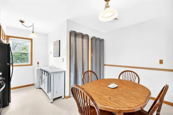 a kitchen with a refrigerator a stove a sink and a window