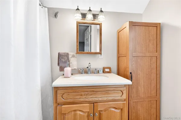 a bathroom with a sink a vanity and a mirror