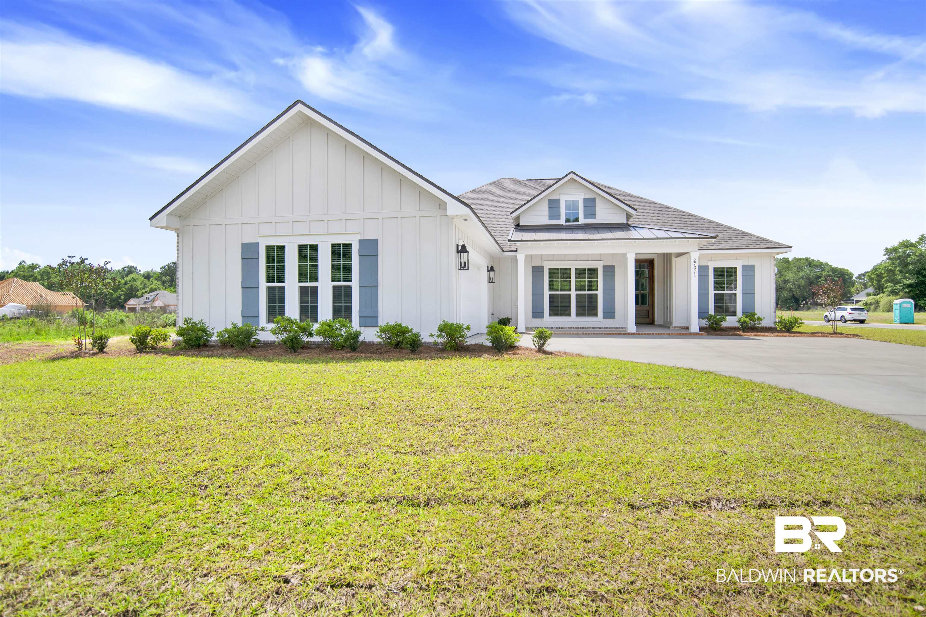 27371 Patch Pl Loop Daphne, AL 36526 - Photo 6 of 63 White board and batten exterior with blue shutters, a dark shingle roof, and a covered entryway