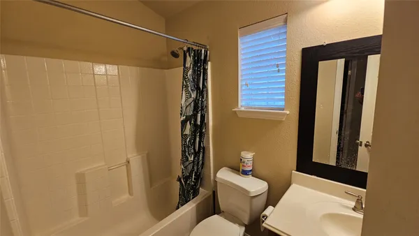 a bathroom with a toilet and shower