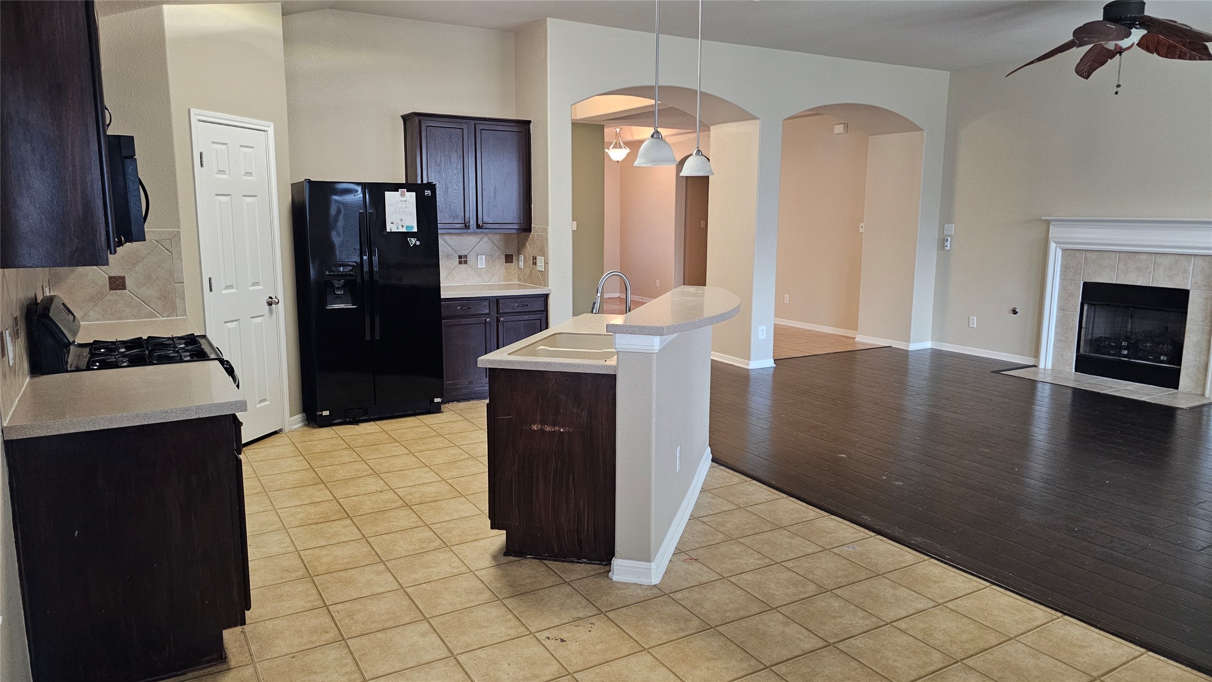 1313 Clary Sage Loop Round Rock, TX 78665 - Photo 7 of 16 a kitchen with granite countertop a refrigerator and a stove top oven