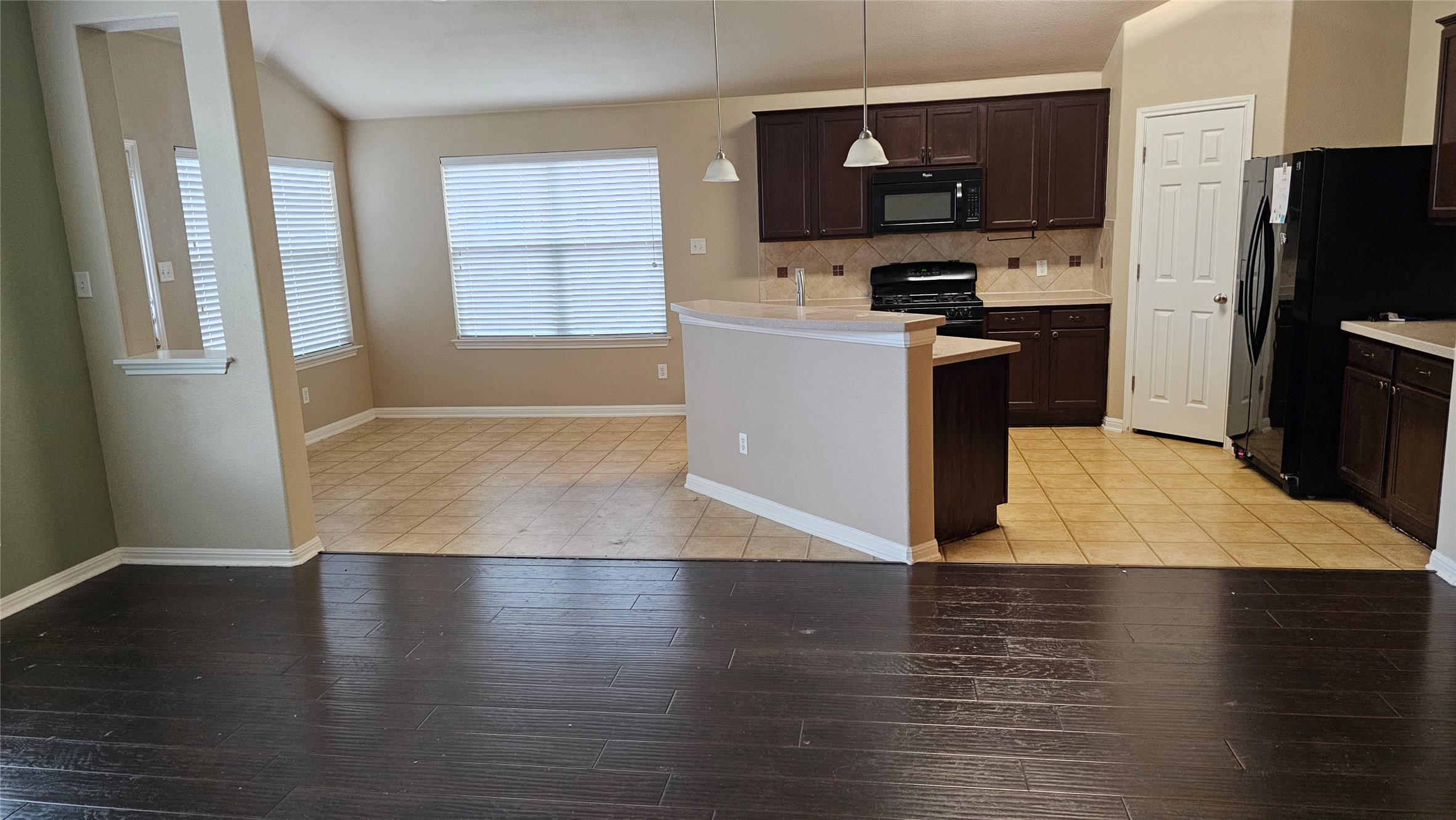 1313 Clary Sage Loop Round Rock, TX 78665 - Photo 8 of 16 a kitchen with stainless steel appliances granite countertop a refrigerator a sink a stove top oven a counter space and cabinets