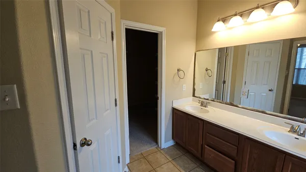 a bathroom with a double vanity sink and mirror