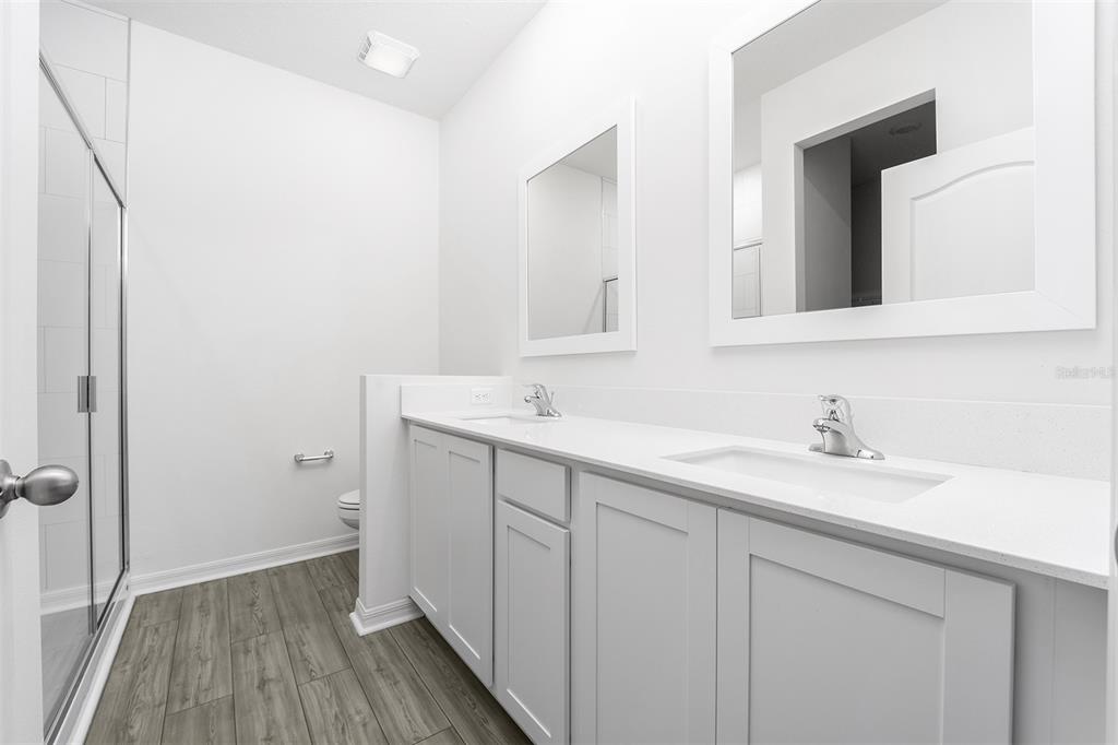 13347 Tula Loop Astatula, FL 34705 - Photo 11 of 21 a bathroom with a sink and a mirror