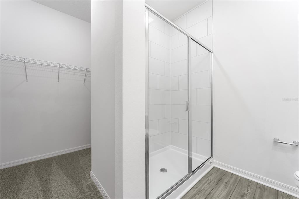 13347 Tula Loop Astatula, FL 34705 - Photo 12 of 21 a bathroom with a glass shower door
