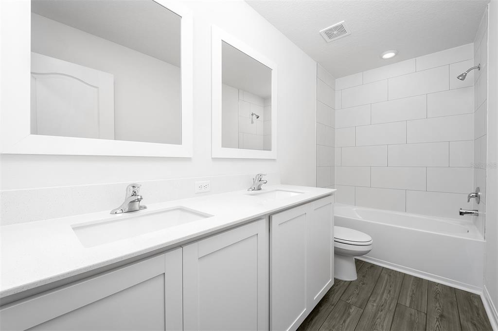 13347 Tula Loop Astatula, FL 34705 - Photo 18 of 21 a bathroom with a sink a toilet and a bathtub
