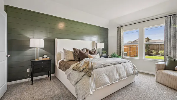 a large bed sitting in a bedroom next to a window