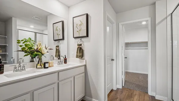 a bathroom with double vanity sink and a mirror