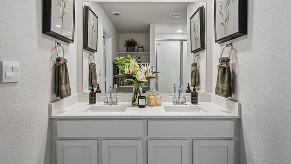 a en suite bathroom with double sink and a mirror