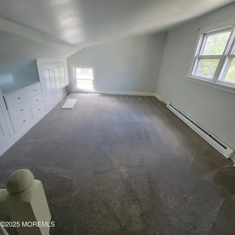 a view of a room with wooden floor staircase and windows