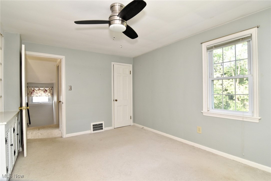 1448 Grenleigh Road Lyndhurst, OH 44124 - Photo 5 of 8 Bedroom with multiple windows, light colored carpet, and ceiling fan
