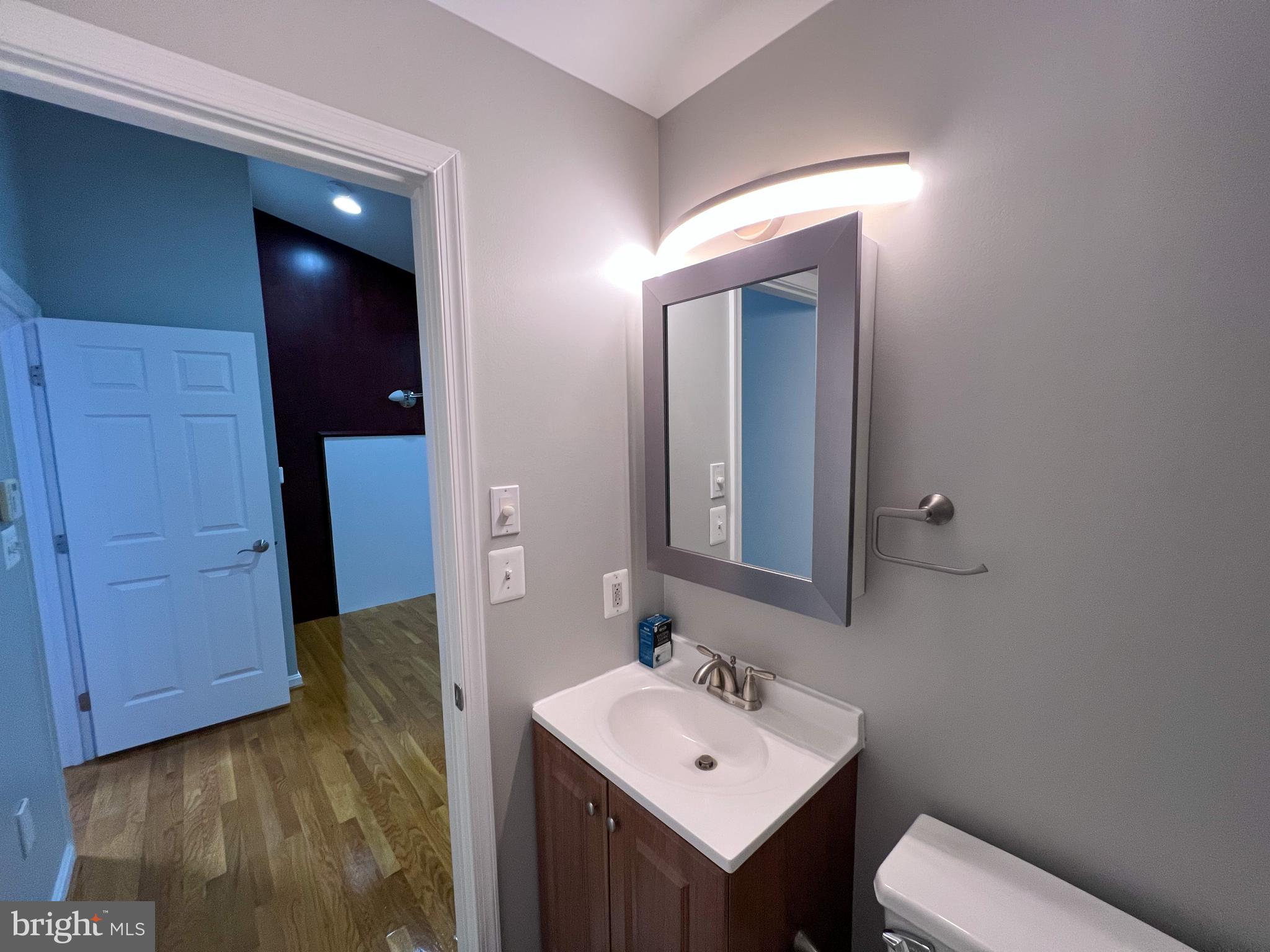 8514 Rhuddlan Road Nottingham, MD 21236 - Photo 21 of 34 a bathroom with a sink a toilet and mirror