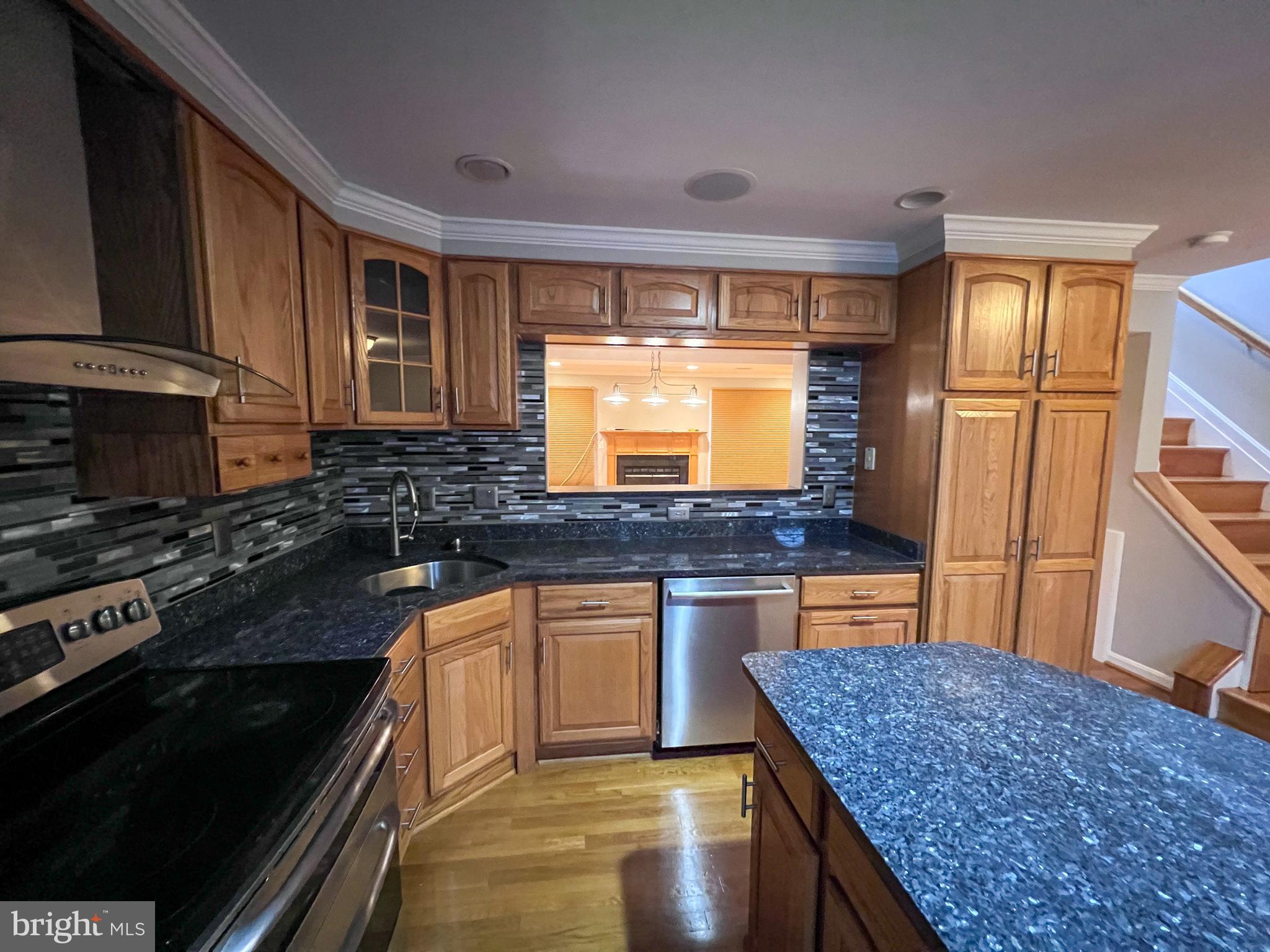 8514 Rhuddlan Road Nottingham, MD 21236 - Photo 32 of 34 a kitchen with stainless steel appliances granite countertop a stove a sink and a microwave