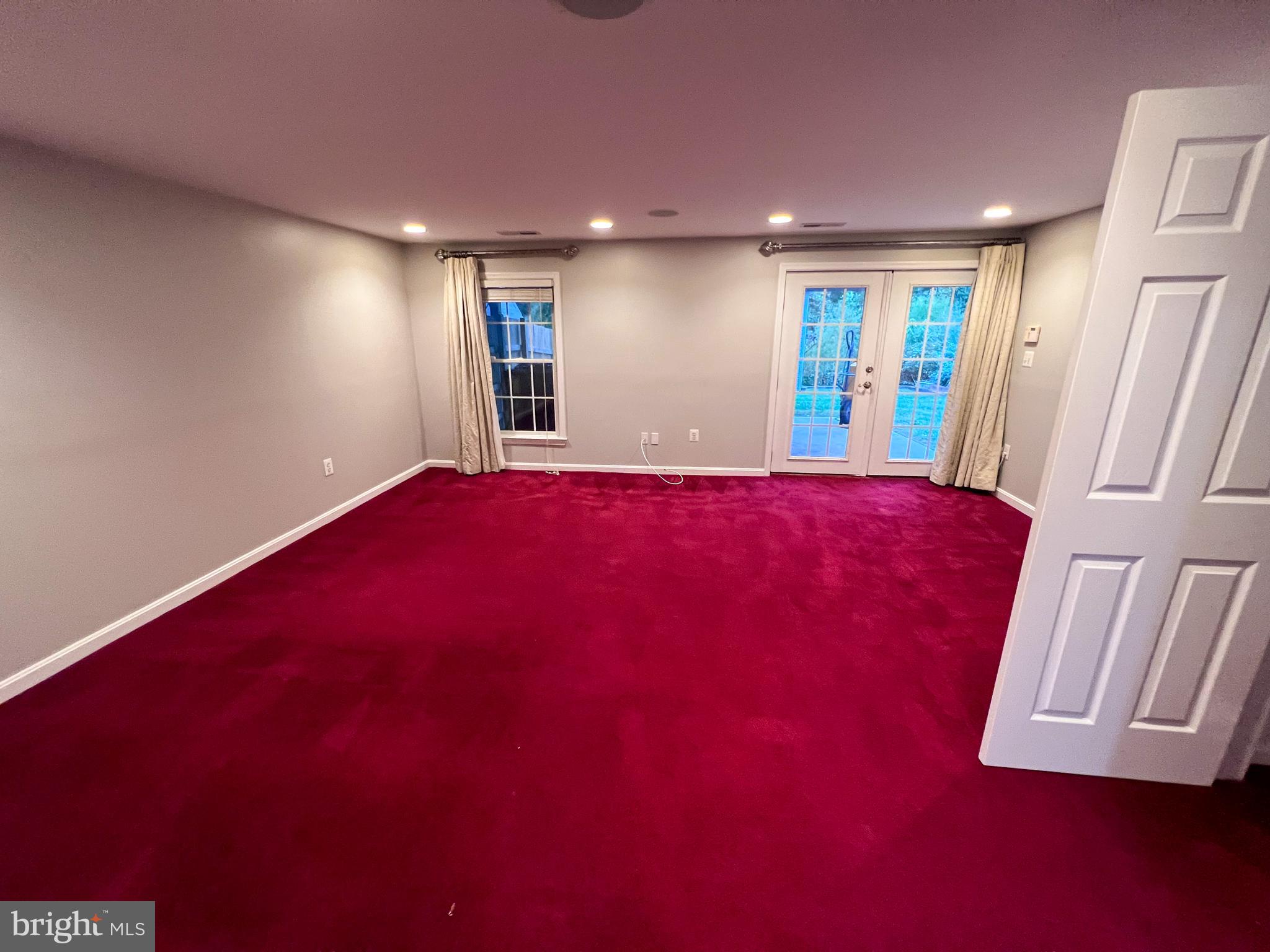 8514 Rhuddlan Road Nottingham, MD 21236 - Photo 9 of 34 a view of an empty room with wooden floor and door