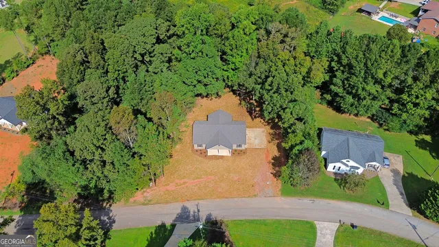 an aerial view of a house with a yard and garden