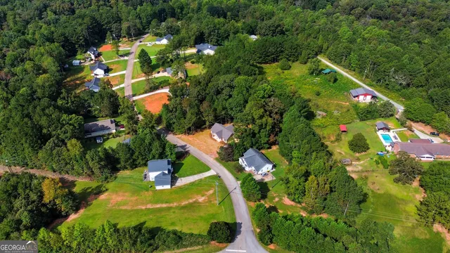 an aerial view of a house with a yard and lake view
