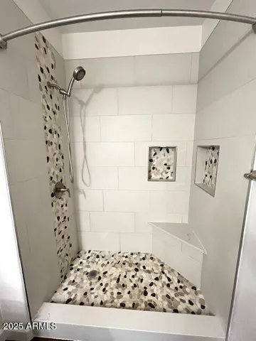a bathroom with a shower and a sink