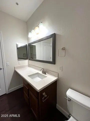 a bathroom with a sink a toilet and mirror