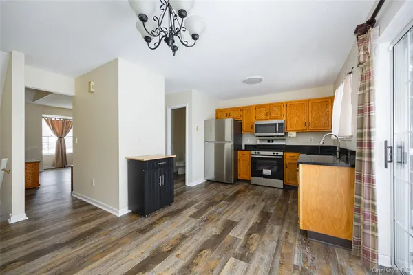 a kitchen with stainless steel appliances granite countertop a refrigerator and a stove top oven