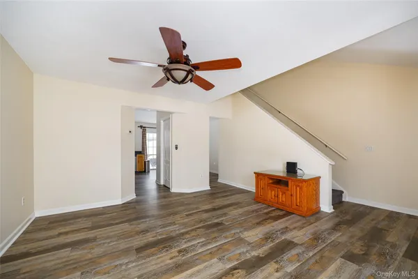 a view of empty room with wooden floor