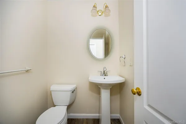 a bathroom with a sink toilet and mirror