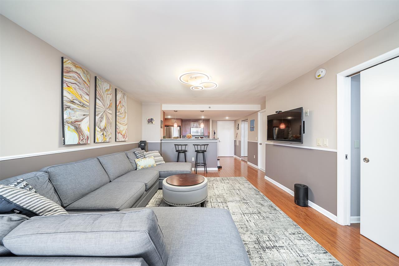 700 Grove Street, Unit 4V Jersey City, NJ 07310 - Photo 8 of 25 a living room with furniture and a flat screen tv