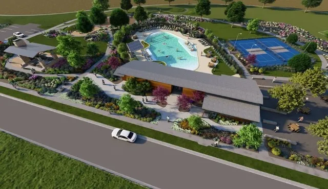 a view of a swimming pool with a yard and sitting area