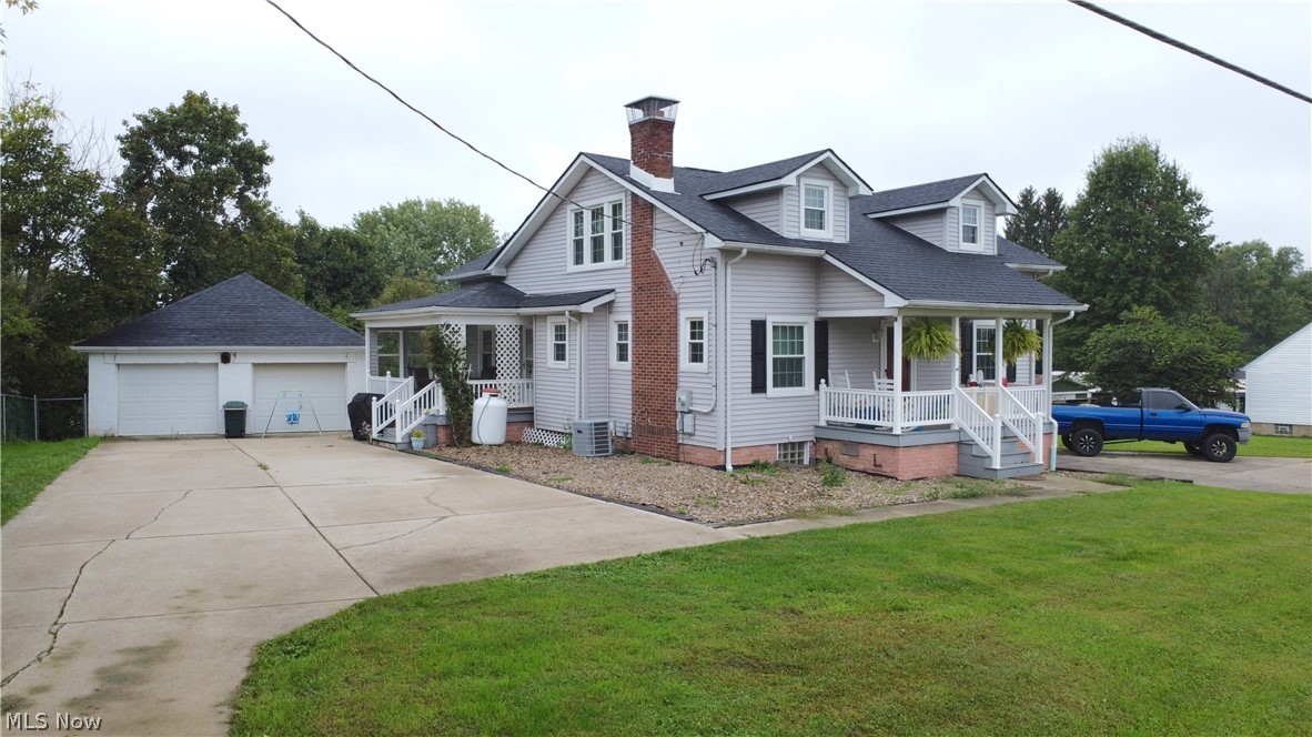 72622 Colerain Road Dillonvale, OH 43917 - Photo 1 of 17 Light gray siding with white trim, a dark shingled roof, and a brick chimney