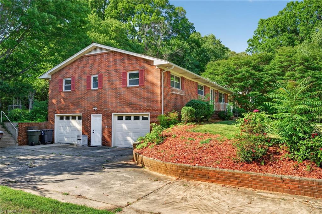113 Green Valley Road Greensboro, NC 27403 - Photo 23 of 46 A spacious two-car garage, generous driveway, and nearly half-acre homesite provide room for everyday living and weekend projects alike.