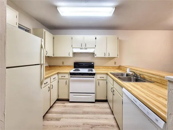 a kitchen with a stove a refrigerator and a sink