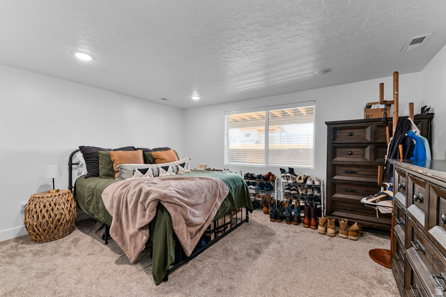 1426 South 1450th Street West Mapleton, UT 84664 - Photo 22 of 50 Spacious room featuring neutral carpeting, a large window with horizontal blinds, and recessed lighting