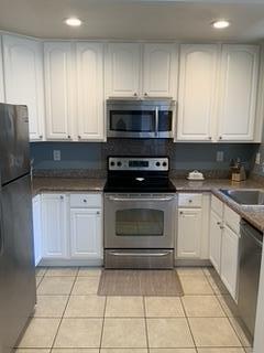 72 Rancho Drive, Unit D San Jose, CA 95111 - Photo 8 of 19 a kitchen with granite countertop a stove a sink and a microwave