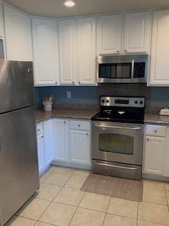 72 Rancho Drive, Unit D San Jose, CA 95111 - Photo 9 of 19 a kitchen with granite countertop white cabinets and stainless steel appliances
