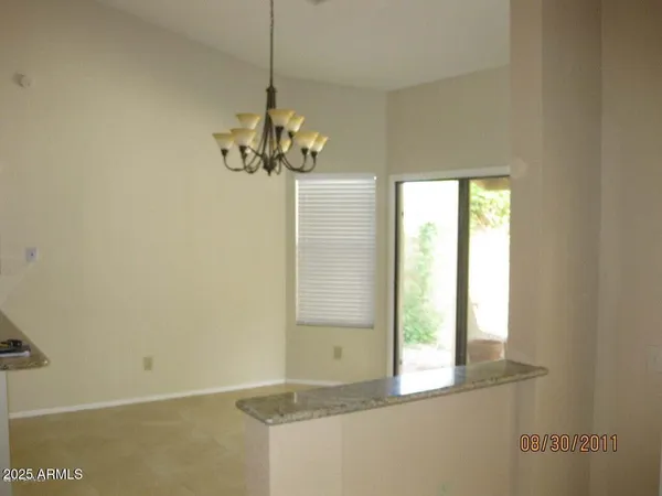 a view of a chandelier fan and entryway