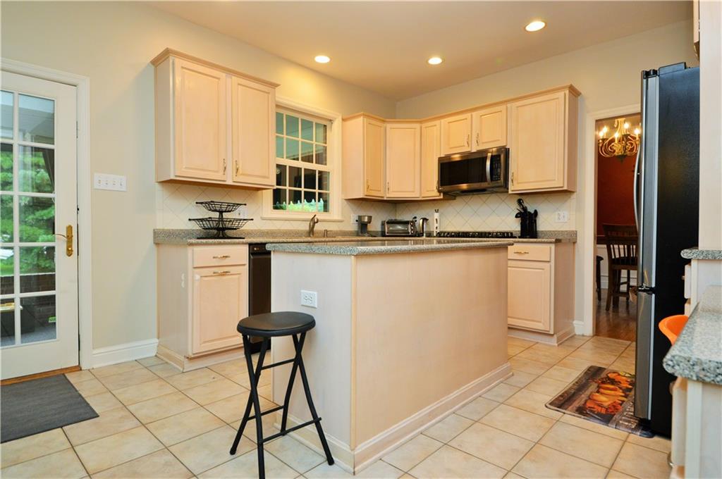 1300 Sara Court Coraopolis, PA 15108 - Photo 11 of 50 a kitchen with stainless steel appliances granite countertop a stove a sink a microwave a refrigerator and cabinets