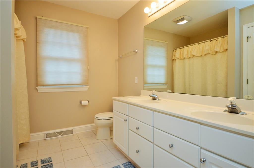 1300 Sara Court Coraopolis, PA 15108 - Photo 32 of 50 a bathroom with a double vanity sink toilet and a mirror