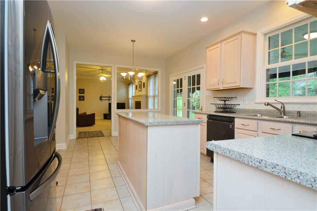 1300 Sara Court Coraopolis, PA 15108 - Photo 9 of 50 a kitchen with stainless steel appliances granite countertop a refrigerator a sink a stove and white cabinets