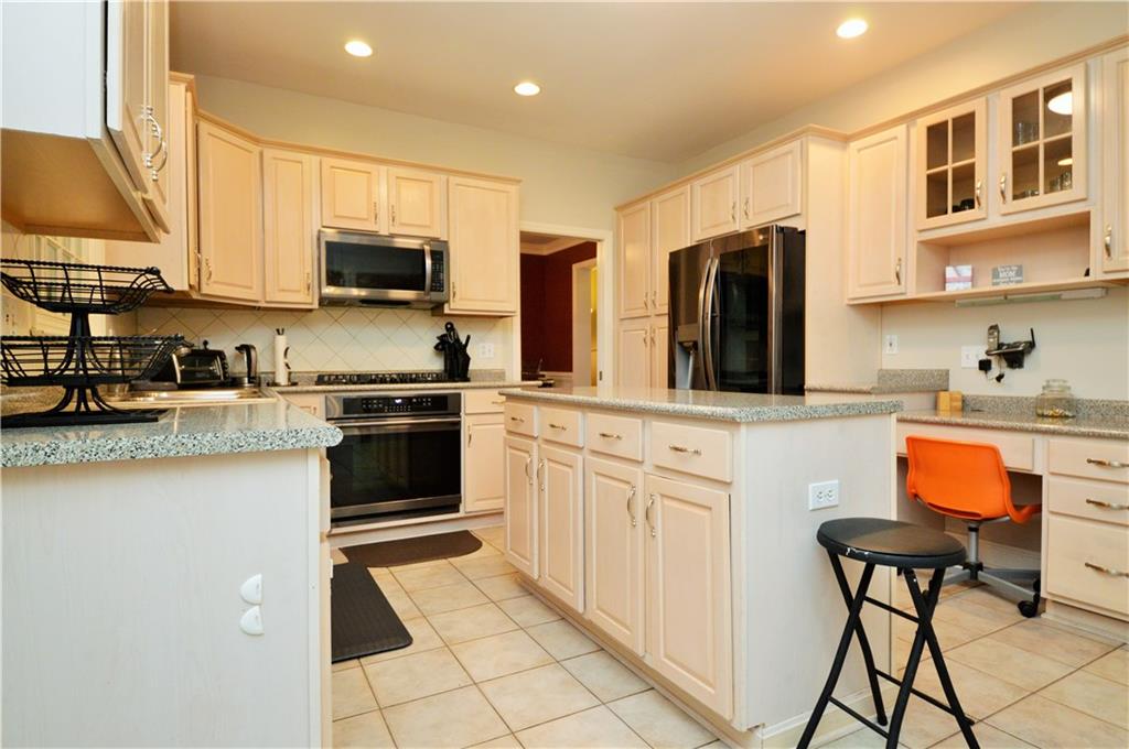 1300 Sara Court Coraopolis, PA 15108 - Photo 10 of 50 a kitchen with stainless steel appliances a stove a sink and a refrigerator