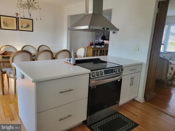 a kitchen with white cabinets and appliances