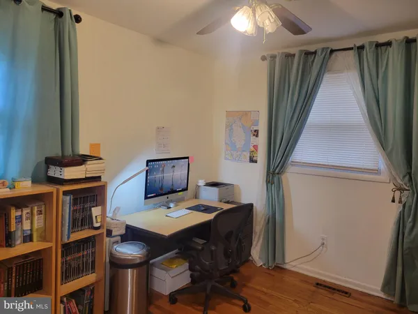 a work room with furniture and a floor to ceiling window