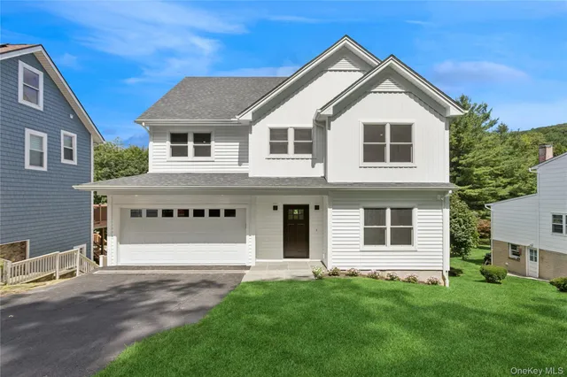 a front view of a house with a garden