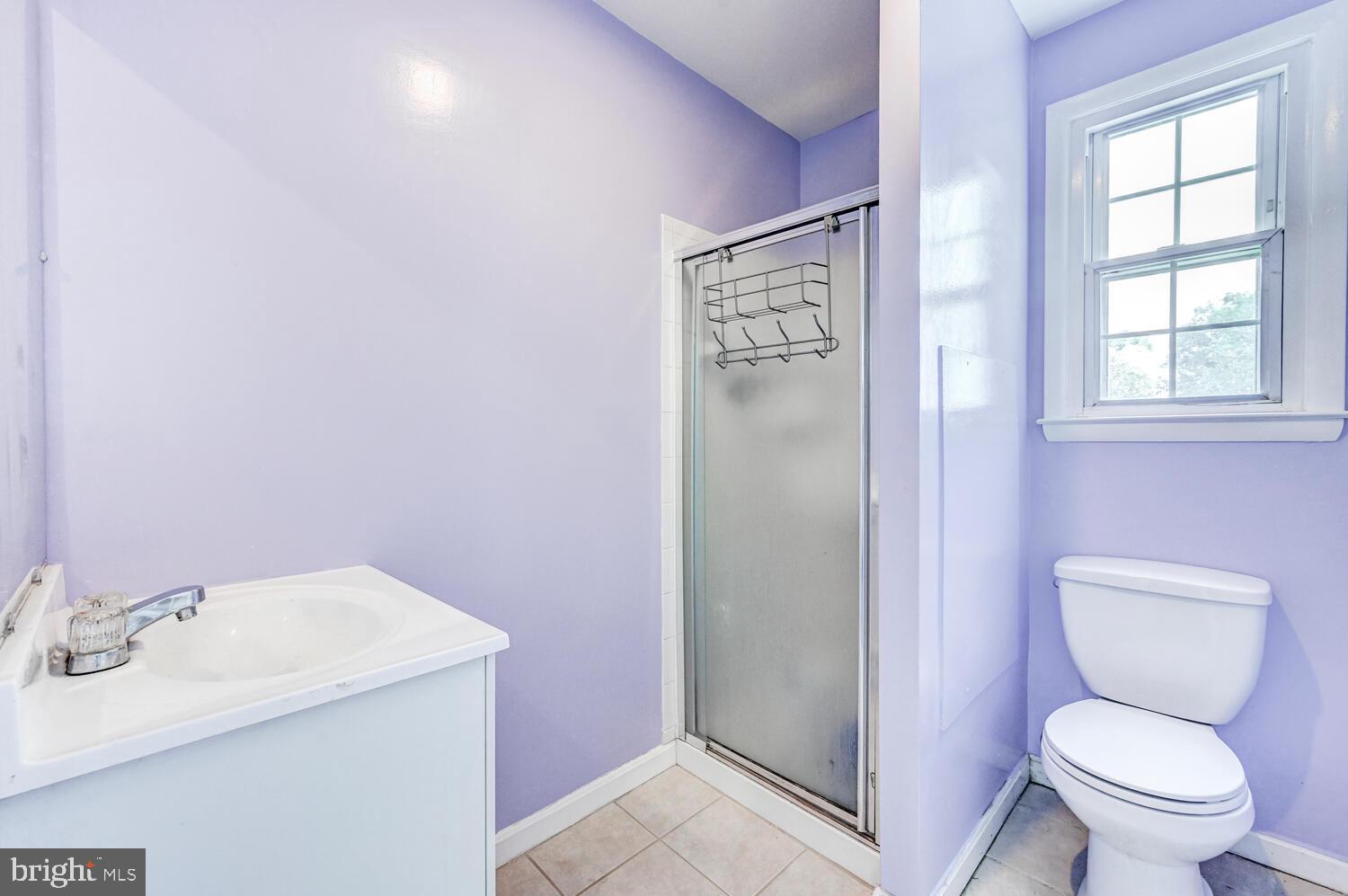 2636 Spring Road Baltimore, MD 21234 - Photo 17 of 25 a bathroom with a sink a toilet and a window