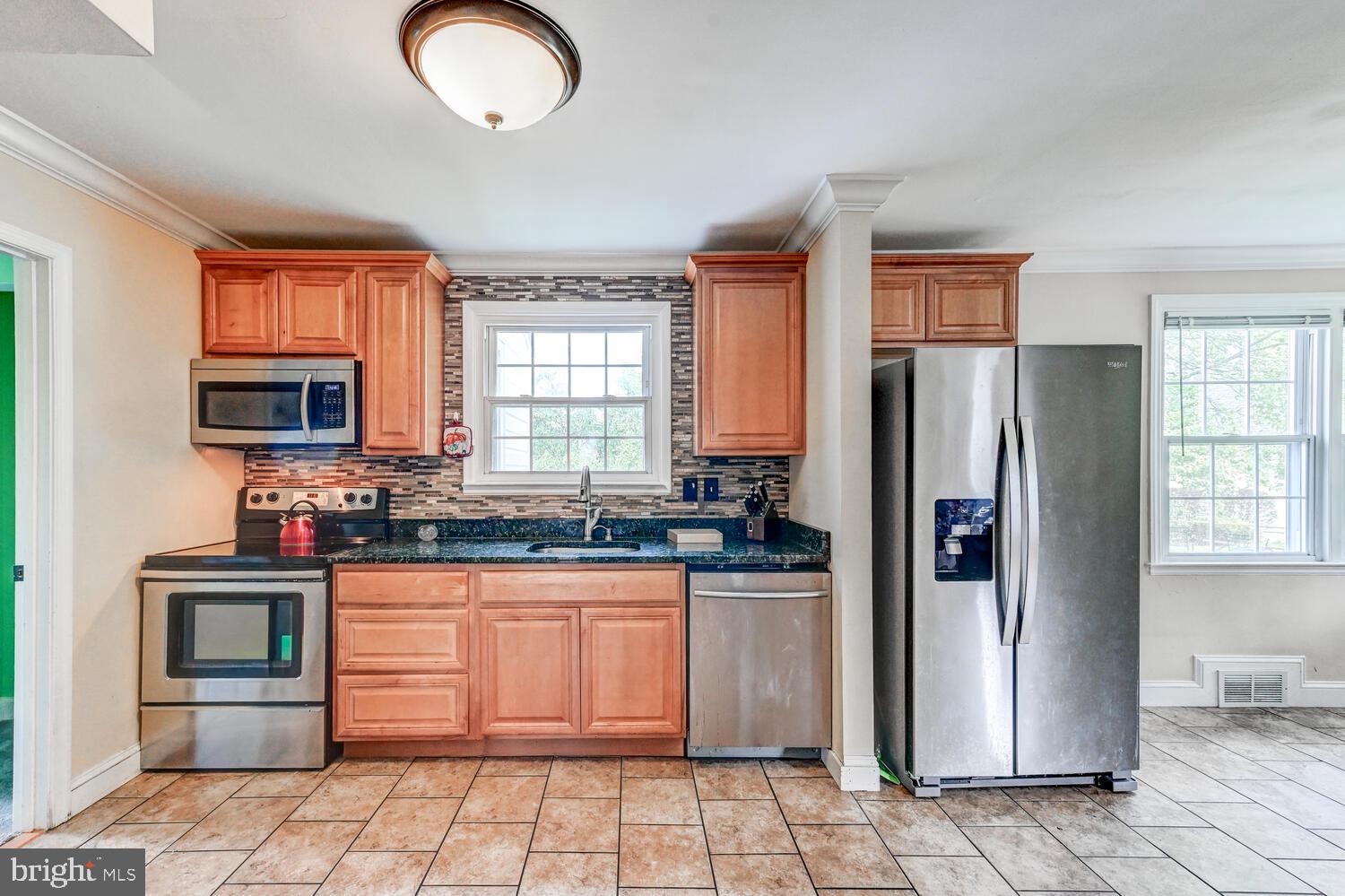 2636 Spring Road Baltimore, MD 21234 - Photo 10 of 25 a kitchen with granite countertop a refrigerator and a sink